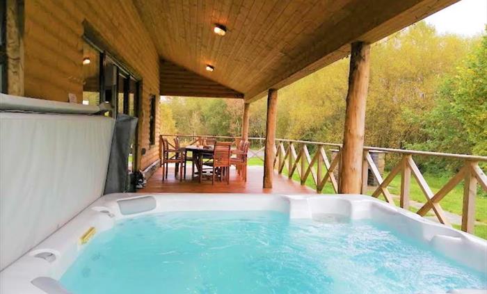 There is a hot tub on the veranda, which seats 8 people.  Under the veranda is a dining area and a BBQ is close by on the lawn.  At night the veranda